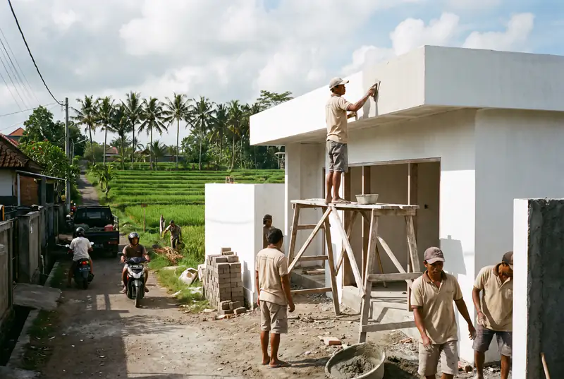 Plasterer finishing smooth white render on a modern villa in Canggu Bali